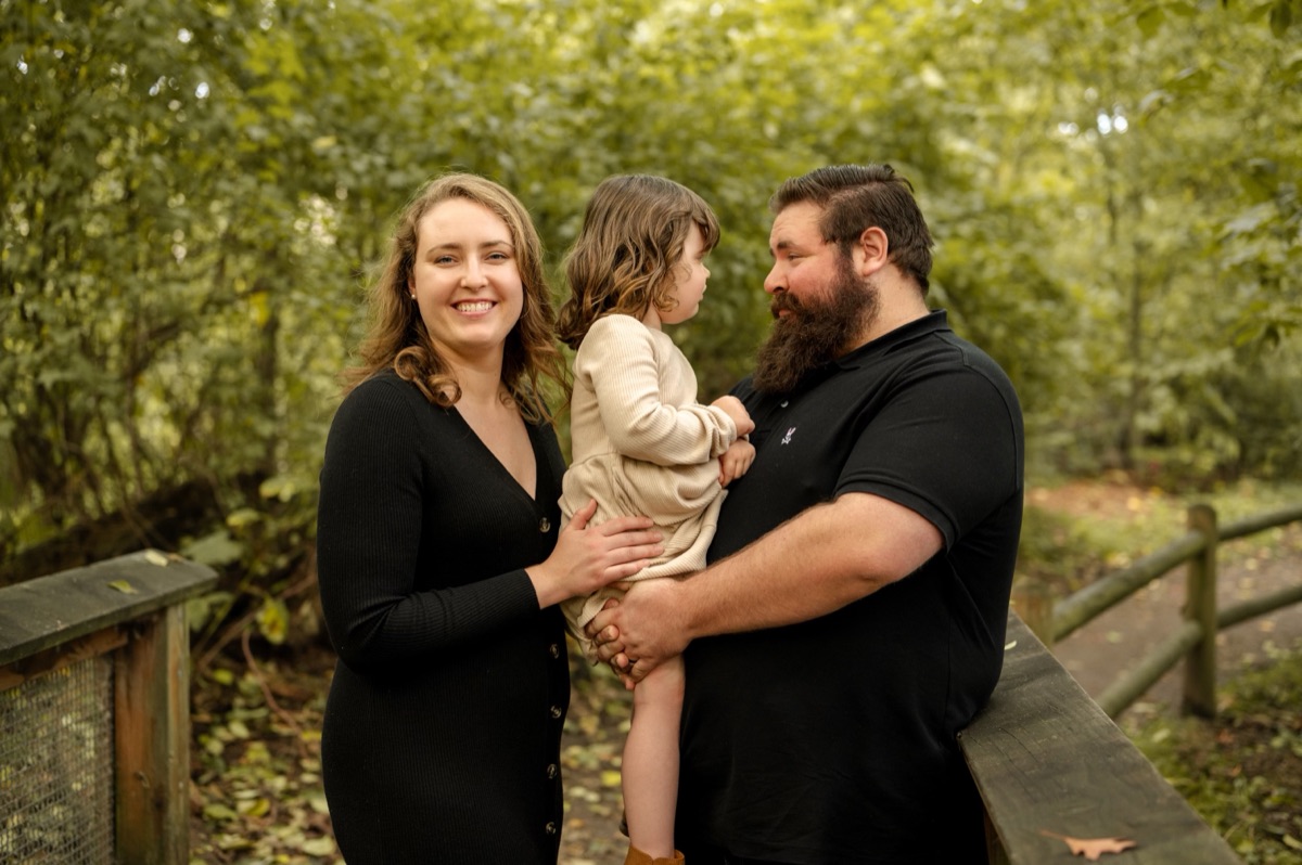 Shane with family on a footbridge in the woods